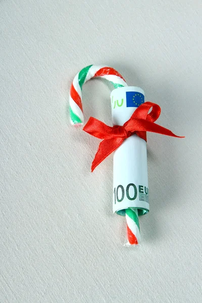 Hundred euro with red ribbon and candy cane — Stock Photo, Image