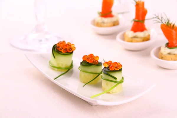 Red caviar on fresh cucumber as snack — Stock Photo, Image