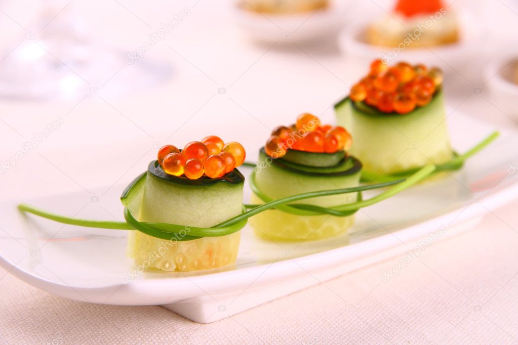 Red caviar on fresh cucumber as snack