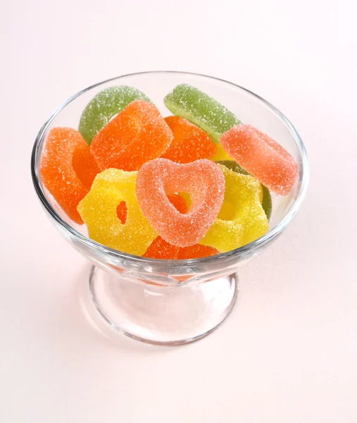 Colored candy with red heart in glass bowl — Stock Photo, Image