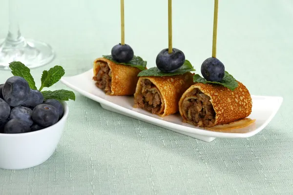 Pancake roll stuffed with minced meat as snack — Stock Photo, Image