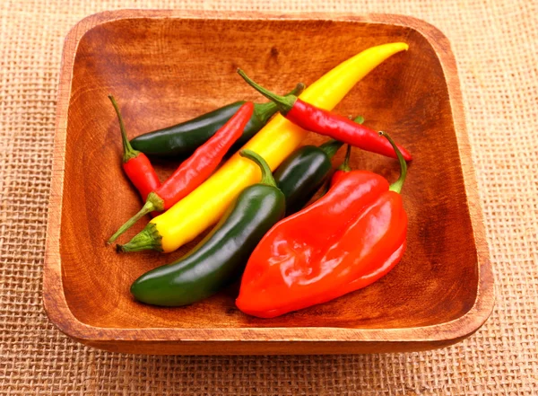Hot pepper varieties in wood bowl — Stockfoto