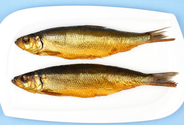 Two kippers, smoked herring on white plate