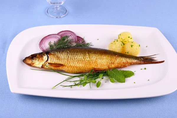 Kippers, smoked herring on a white plate with garnish — Stock Photo, Image