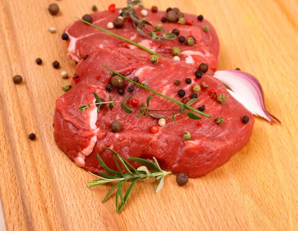 Two juicy beef steak with spices and onion — Stock Photo, Image