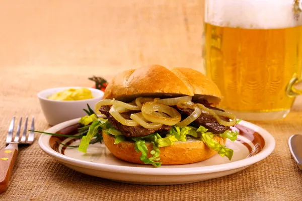 Ochsen semmel - gegrilde rundvlees met uienringen in broodje — Stockfoto