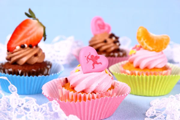 Appetizing cupcakes with angel, heart, tangerine, strawberry — Stock Photo, Image