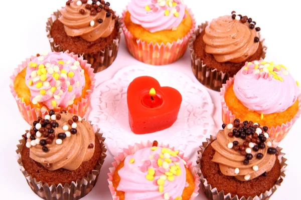 Chocolate and pink cup cakes with candle heart, top view — Stock Photo, Image