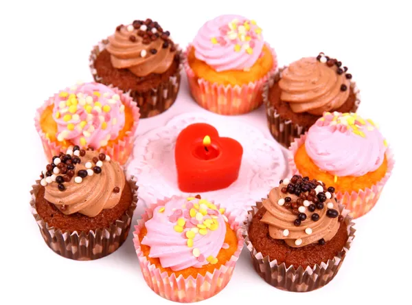 Chocolate and pink cup cakes with candle heart — Stock Photo, Image