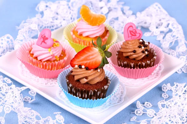 Assorted cup cakes with angel, heart, tangerine, strawberry — Stock Photo, Image