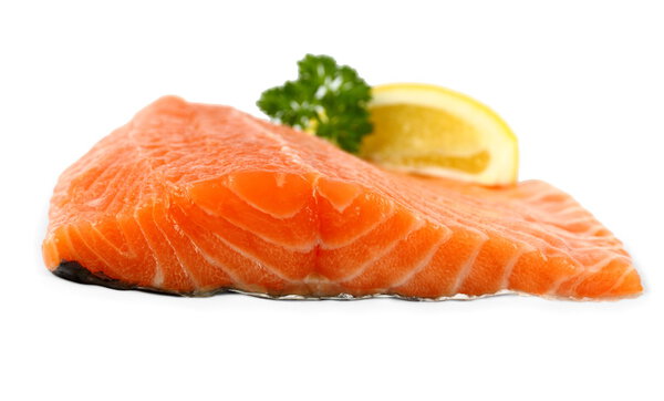 Raw, red salmon fillet with lemon wedge, frontal