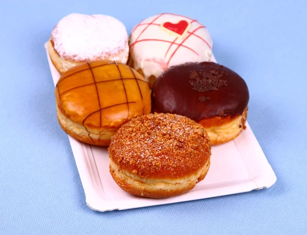 Cinco deliciosos e variados donuts no prato — Fotografia de Stock