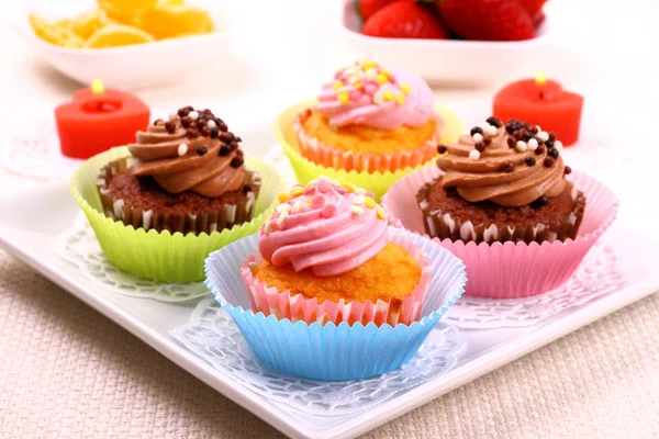Four appetizing cupcakes on white plate — Stock Photo, Image