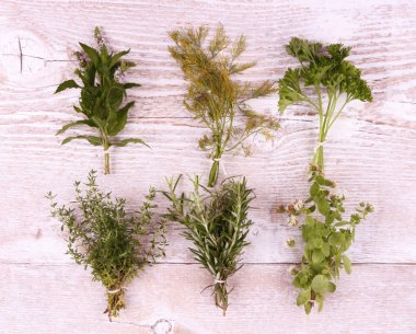 Beyaz ahşap zemin üzerinde pakette bulunan İtalyan otlar