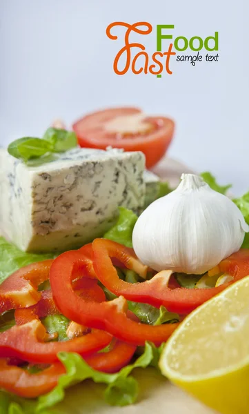 Italian food (cheese, garlic, pepper, basil, salad) over white — Stock Photo, Image