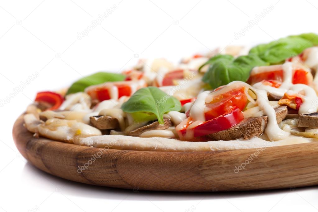 Vegetarian pizza with peppers, mushrooms, tomatoes, olives and b