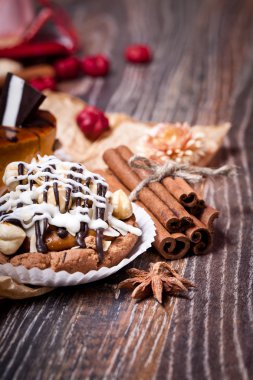 Coffee cakes with chocolate, spices and coffee seeds, close up