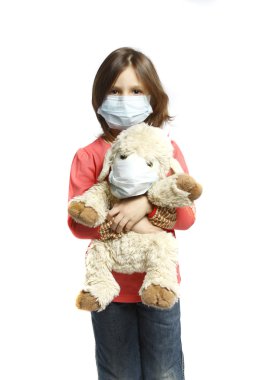 Little girl with toy wearing a protective mask