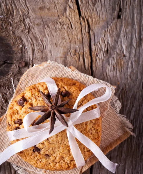 Stacked chocolate chip cookies on wooden table — Stock Photo, Image