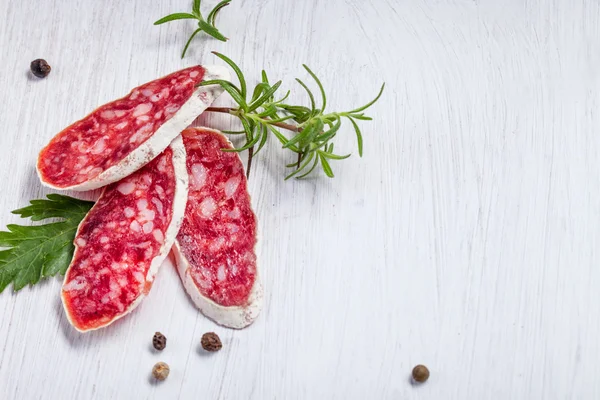 Salami with rosemary — Stock Photo, Image