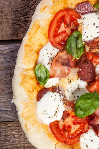 Pizza with salami, tomato and ham — Stock Photo, Image