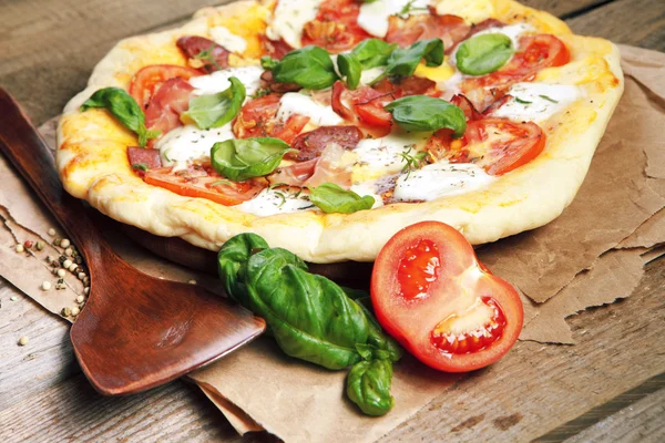 Pizza with dry cured ham and basil — Stock Photo, Image