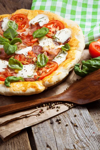 Pizza with dry cured ham and basil — Stock Photo, Image