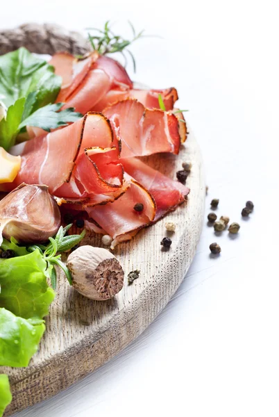 Prosciutto, cheese, salami, herbs — Stock Photo, Image
