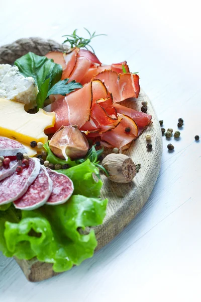 Prosciutto, cheese, salami and herbs — Stock Photo, Image