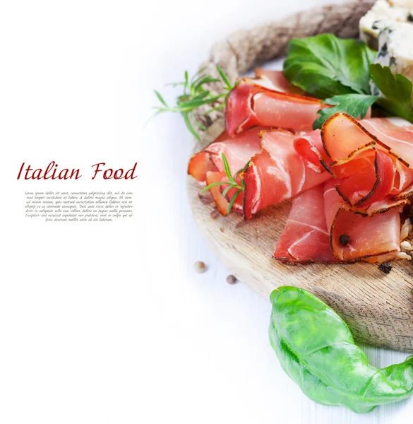 Prosciutto with salami, cheese and basil — Stock Photo, Image