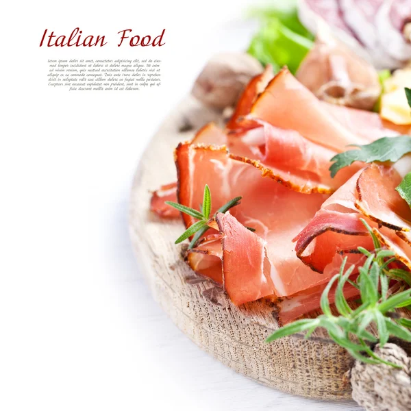 Prosciutto, cheese, salami, herbs — Stock Photo, Image