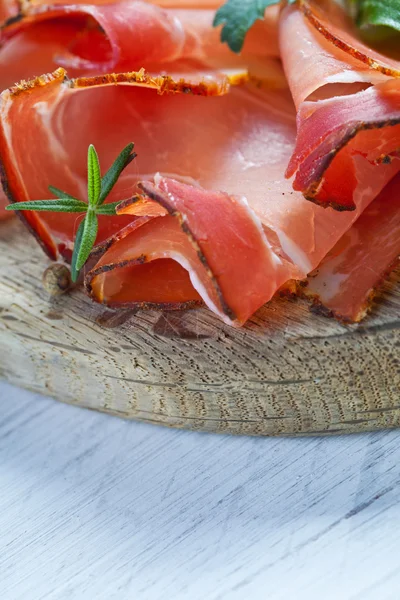 Prosciutto, cheese, salami and herbs — Stock Photo, Image