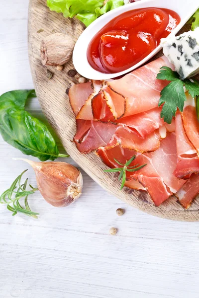 Prosciutto with salami, cheese and basil — Stock Photo, Image