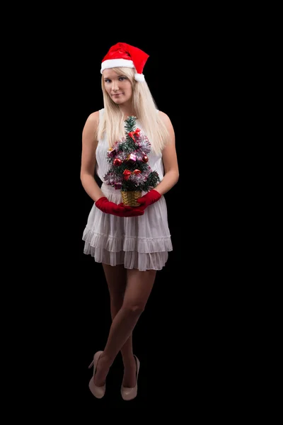 Girl in red Santa hat with Cristmass tree — Stock Photo, Image