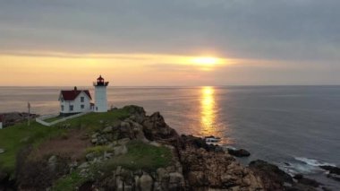 Nubble Lighthouse along the coast of Maine at sunrise. 