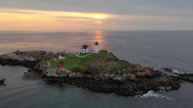 Nubble Lighthouse along the coast of Maine at sunrise. 