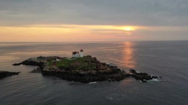 Nubble Lighthouse along the coast of Maine at sunrise. 