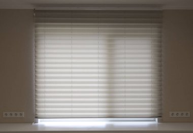 Pleated blinds XL, white color, with 50mm fold close up in the window opening in the interior. Luxury sun protection and window decoration. Modern shades.
