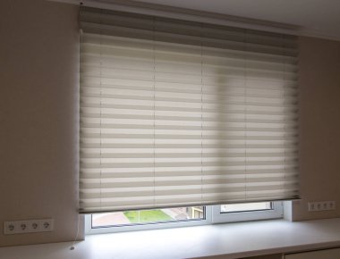 Pleated blinds XL, white color, with 50mm fold close up in the window opening in the interior. Luxury sun protection and window decoration. Modern shades.