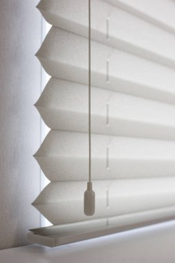 Pleated blinds size XL, Coulisse, 50mm fold, close up on the window, white color, white background. Modern pleated shades, luxury sun protection and window decoration. clipart