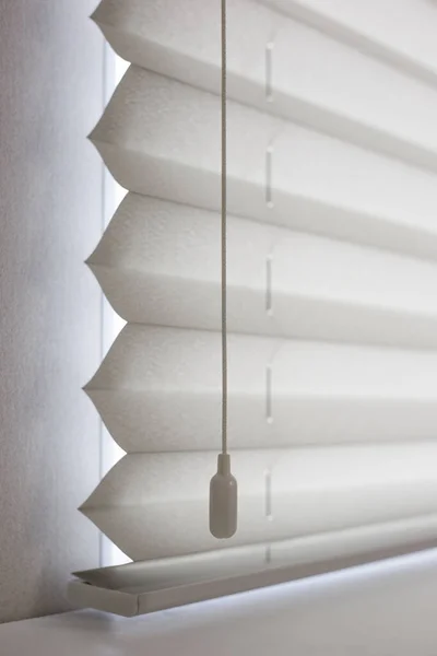 Pleated blinds size XL, 50mm fold, close up on the window, white color, white background. Modern pleated shades, luxury sun protection and window decoration.
