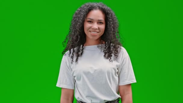 Молода жінка на зеленому екрані показує любовний символ — стокове відео