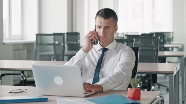 Manager talking by mobile looking on display computer — ストック動画