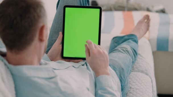 Unrecognizable Man Lying Couch Wearing Casual Shirt Using Digital Tablet — Stockvideo