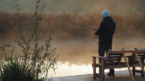 Man Holding Fishing Rod Sitting Riverside River Shrouded Mist Sunrise — Video