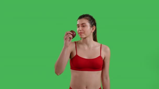 Portrait Slim Woman Eating Apple Looking Camera Smiling Dressed Red — Wideo stockowe