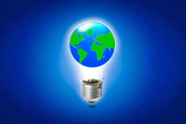 World in light bulb on blue background — Stock Photo, Image