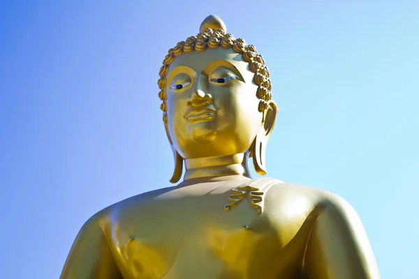 Golden Buddha sculpture on blue background — Stock Photo, Image