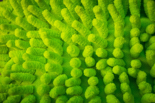 Green microfiber dust mop texture, background.