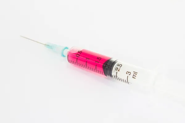 Syringe with red liquid on white background — Stock Photo, Image